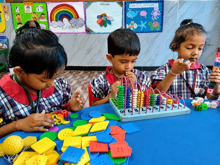 Pre-primary children learning with an abacus and blocks